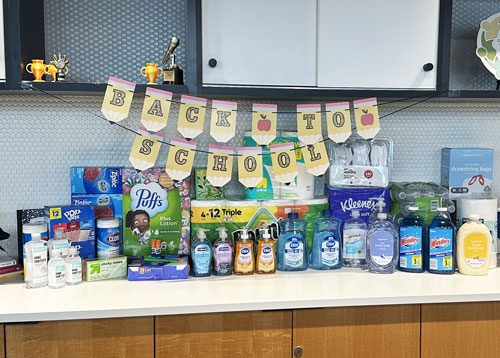 donations of food and sanitary items sitting on a table in the Core Bank office