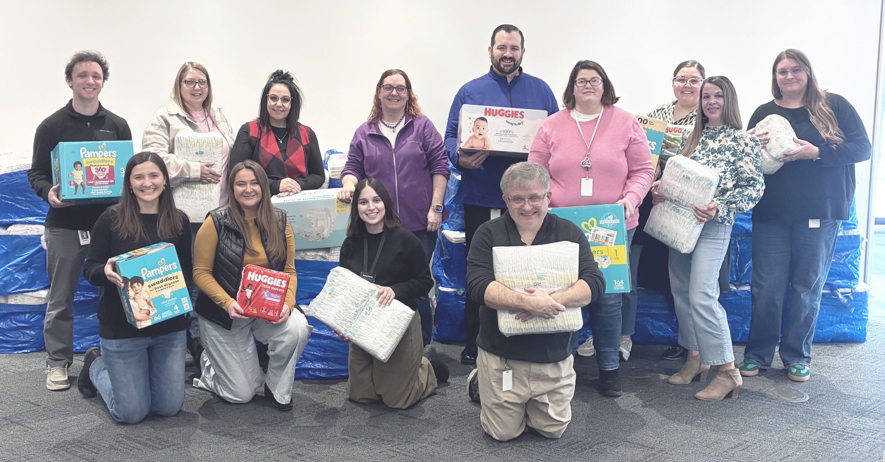 Core Bank employees posing with the diapers that were wrapped and donated during the Core Bank 2025 diaper drive