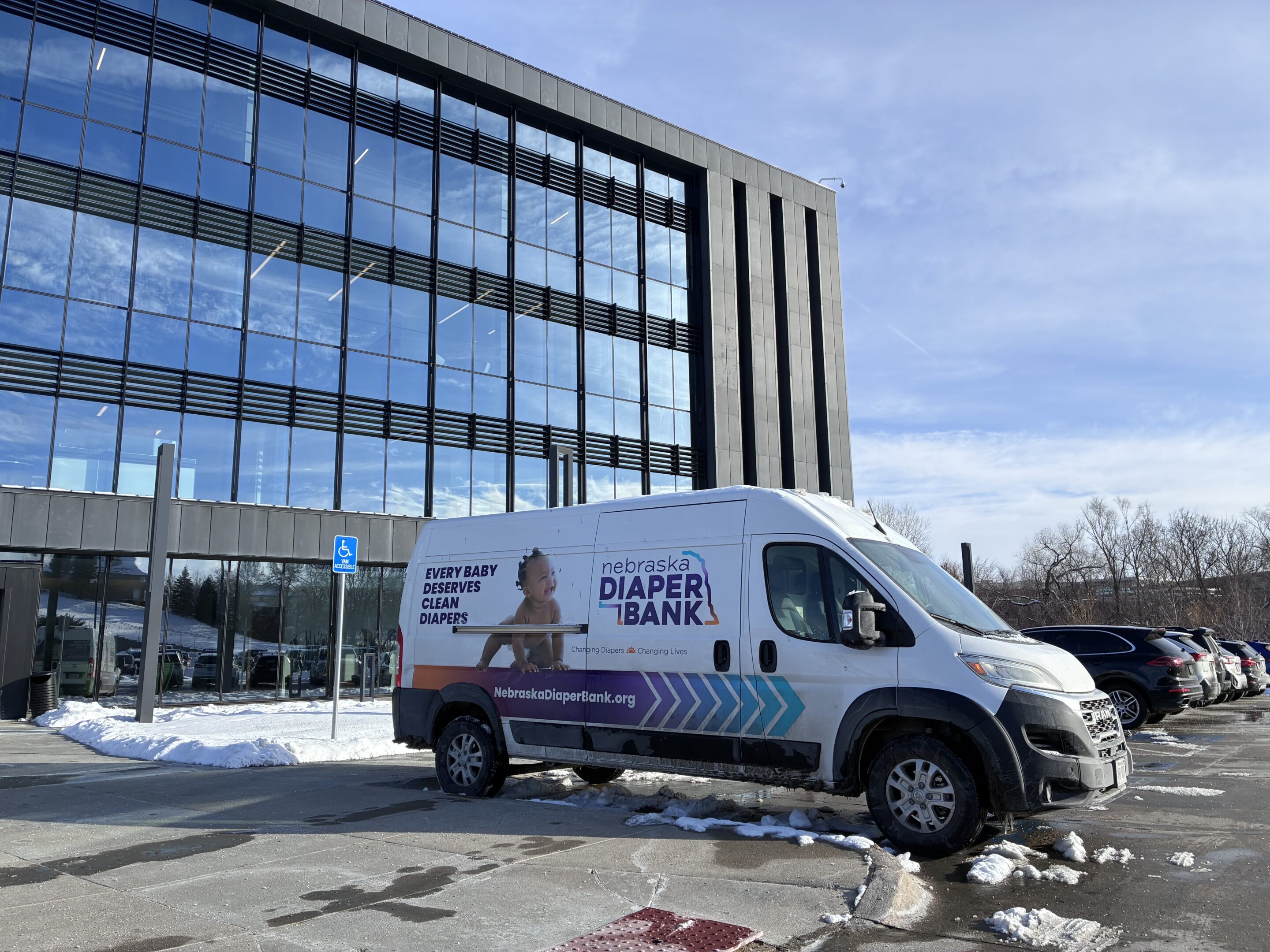 Nebraska Diaper Bank's Mobile Diaper Wrapping Van parked outside of Core Bank HQ.